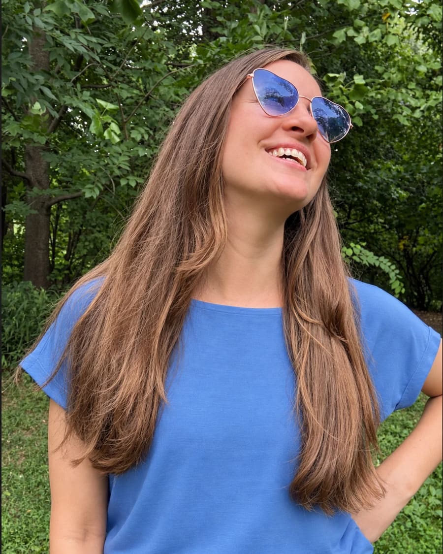 Liz McKenna smiling in heart-shaped sunglasses